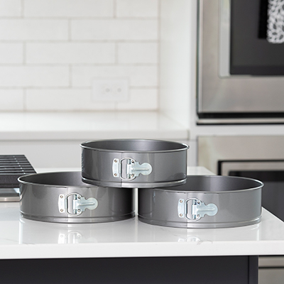 NORPRO<sup>&reg;</sup> 3-pc Springform Pan Set - Bake your favorite cakes, quiches, and more with this set!  Features durable steel construction with nonstick coating for effortless release and easy cleanup.  Spring latch also securely holds form together, offering a tight leak proof seal.  Set includes 3 pans;  9&quot;, 10&quot;, and 10.5&quot; pan.  Handwashing is recommended.